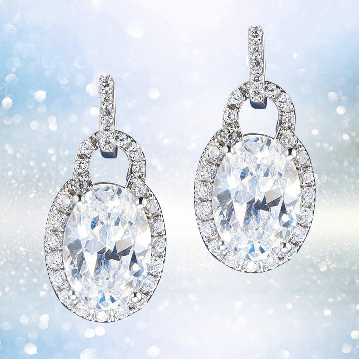 Oval Padlock Earrings crafted in sterling silver, featuring sparkling oval-shaped stones surrounded by a halo of smaller crystals for an elegant feminine jewelry look.