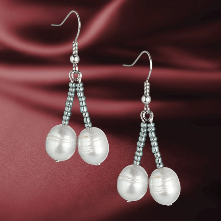 Dove Silver Pearl Earrings featuring delicate silver beads and elegant pearl drops designed for a refined feminine jewelry collection.