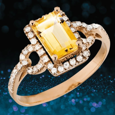 Prosperity Ring featuring a sterling silver band plated in rose gold, adorned with a rectangular yellow gemstone and surrounded by sparkling clear crystals, designed for women.