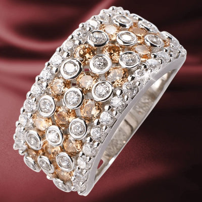 Valencia Ring, a sterling silver ring for women, featuring an intricate design with white and champagne-colored gemstones set in multiple rows for a luxurious jewelry statement.