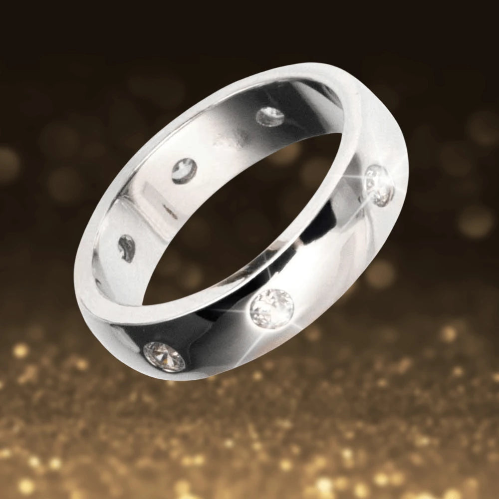 Puccini Ring Rhodium crafted from sterling silver with a rhodium plating, featuring embedded sparkling stones in a sleek unisex band design.