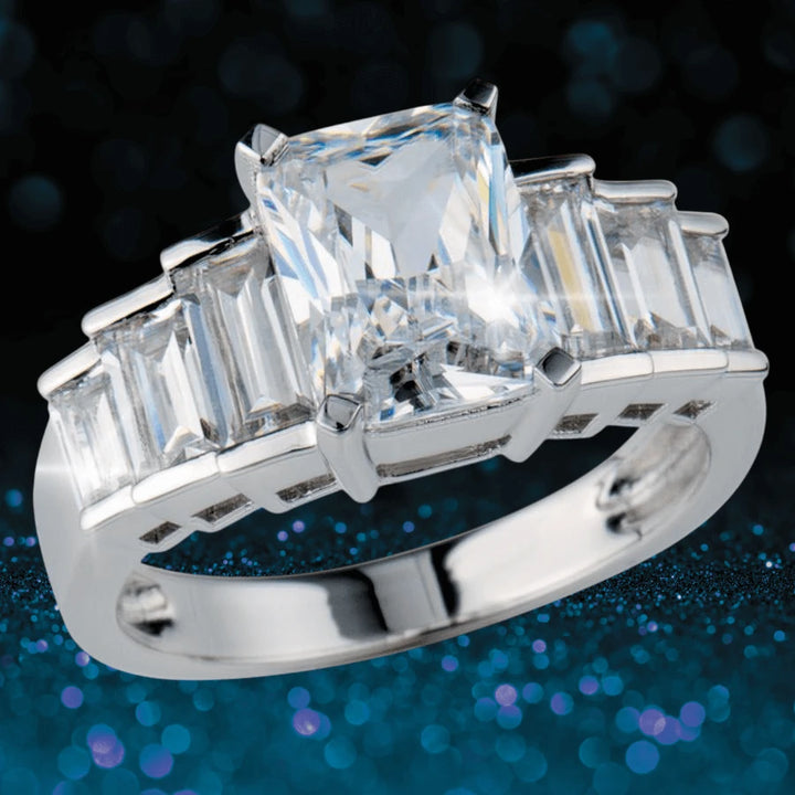 Trinity Ring in sterling silver featuring a prominent rectangular clear gemstone centerpiece with smaller rectangular stones set along the band, designed for female jewelry enthusiasts.