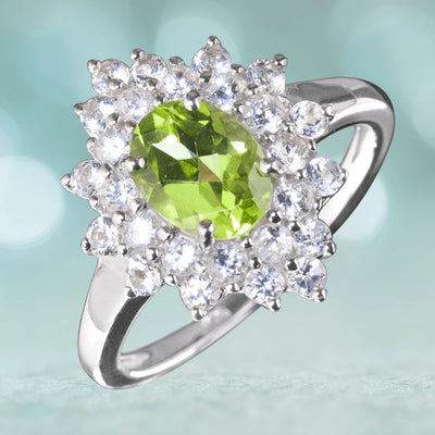 Peridot Cluster Ring featuring a sterling silver band with rhodium plating, accented by a vibrant green peridot center stone surrounded by sparkling clear gemstones, designed for women.