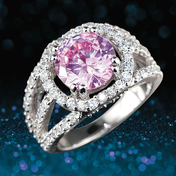 Blush Halo Ring featuring a sterling silver band with rhodium plating, showcasing a large pink centerpiece stone surrounded by sparkling clear accents in an elegant design for women.