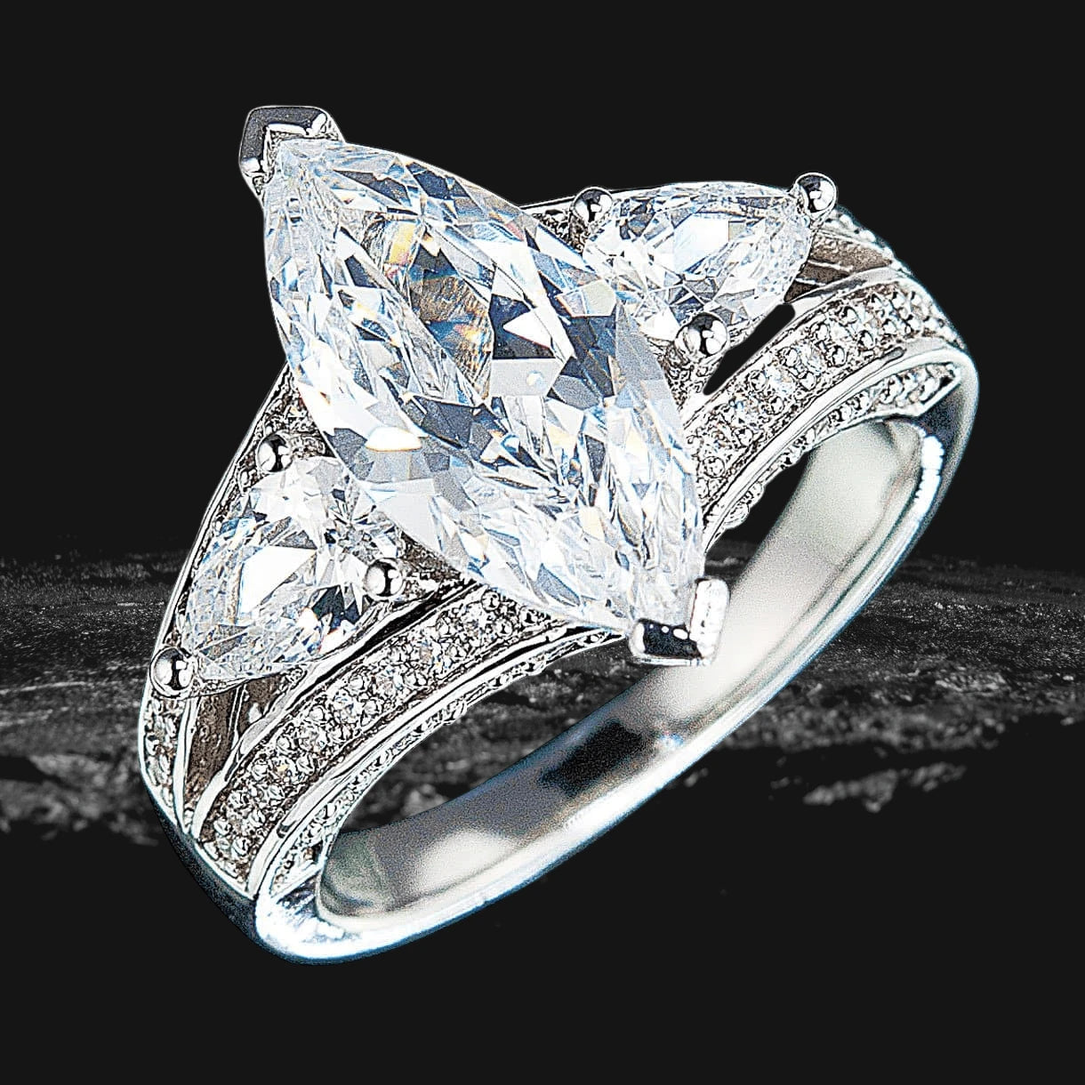 Millionaire Marquise Ring featuring a sterling silver band with rhodium plating, adorned with a large marquise-cut center stone and smaller sparkling accents, designed for women.