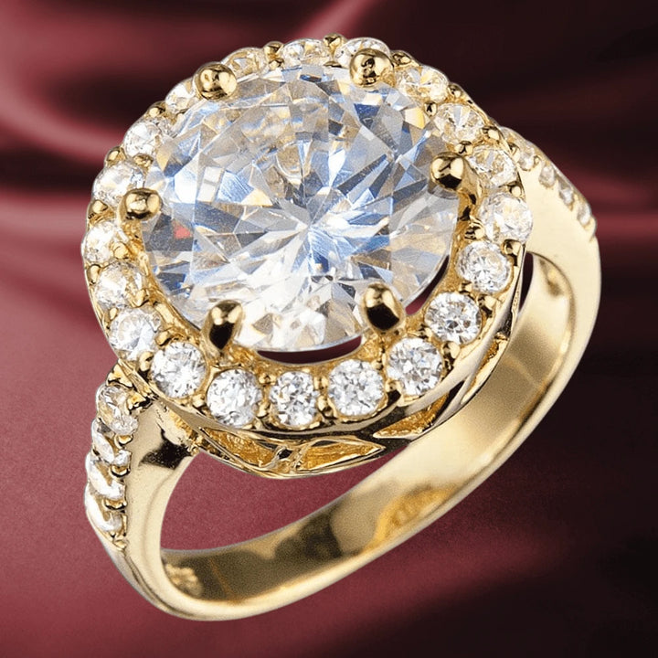 Versailles Gold Ring featuring a large sparkling center stone surrounded by smaller clear crystals set in gold-plated sterling silver, designed for women’s jewelry collections.