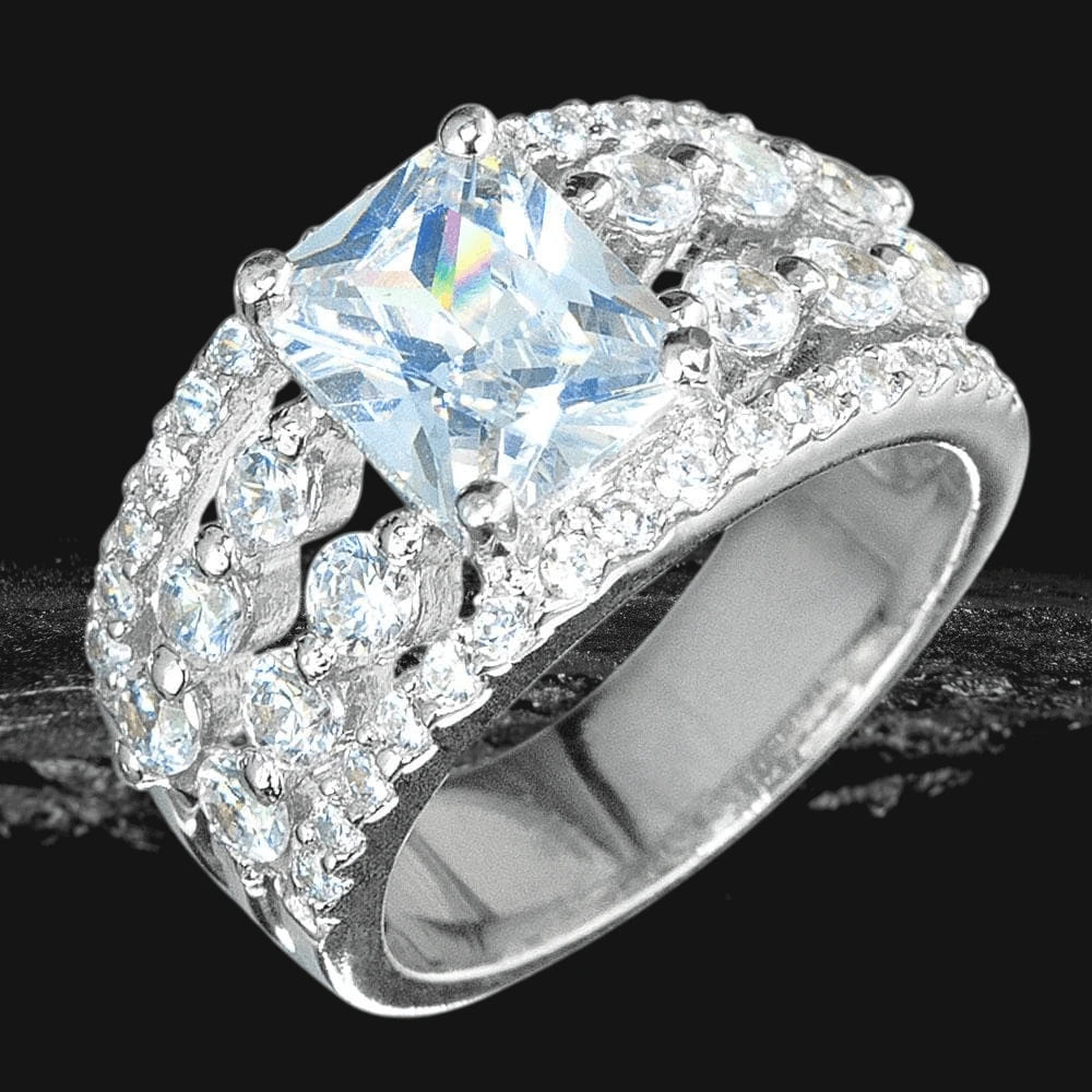 Radiant Ring featuring a sterling silver band with rhodium plating, adorned with sparkling clear stones in an elegant, wide design suitable for female jewelry enthusiasts.