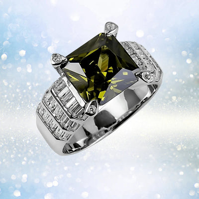 Close-up of the Envy Ring for female, crafted from sterling silver with rhodium plating, featuring a large square green gemstone center and baguette-cut accent stones on the band.