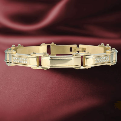 Men's Definition Bracelet in gold-plated stainless steel with a sleek design and embedded clear stones, displayed on a rich burgundy fabric background, showcasing elegant men's jewelry.