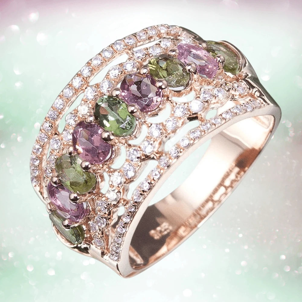 Aurora Ring in sterling silver with rose gold plating, featuring alternating green and purple gemstones surrounded by sparkling clear crystals, designed for women’s jewelry.