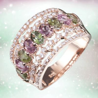 Aurora Ring in sterling silver with rose gold plating, featuring alternating green and purple gemstones surrounded by sparkling clear crystals, designed for women’s jewelry.