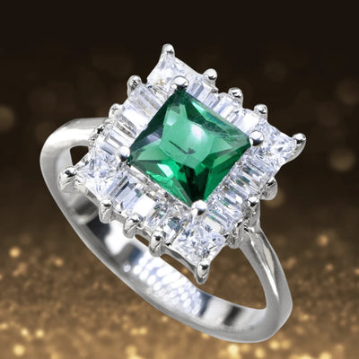 Gatsby Ring featuring a sterling silver band with rhodium plating, showcasing a central emerald-green gemstone surrounded by sparkling clear stones, designed for female jewelry lovers.