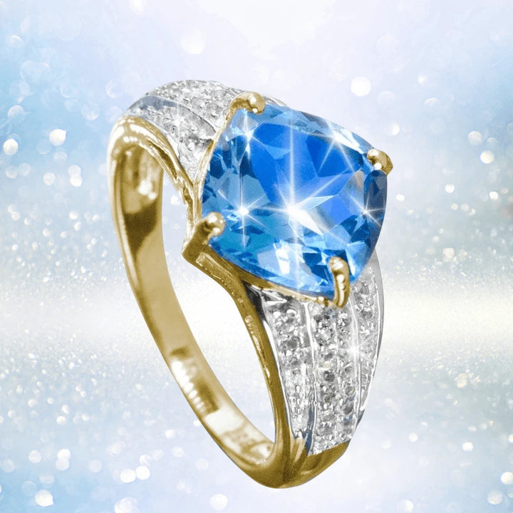 Luxe Swiss Topaz Ring featuring a large blue topaz gemstone set in sterling silver with gold plating, designed for women and accented with small sparkling stones.