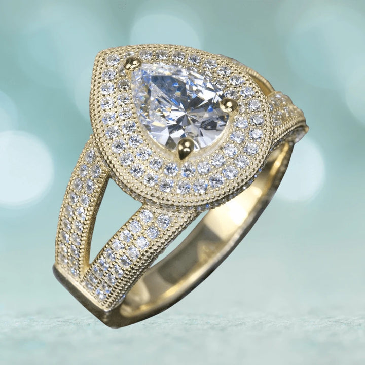 Cullinan Ring featuring a pear-shaped center stone surrounded by sparkling sterling silver with gold plating, designed elegantly for women’s fine jewelry collections.