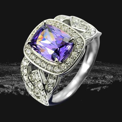 Heather Ring featuring a sterling silver band with rhodium plating, showcasing a large purple gemstone surrounded by smaller sparkling stones, designed for women’s jewelry.
