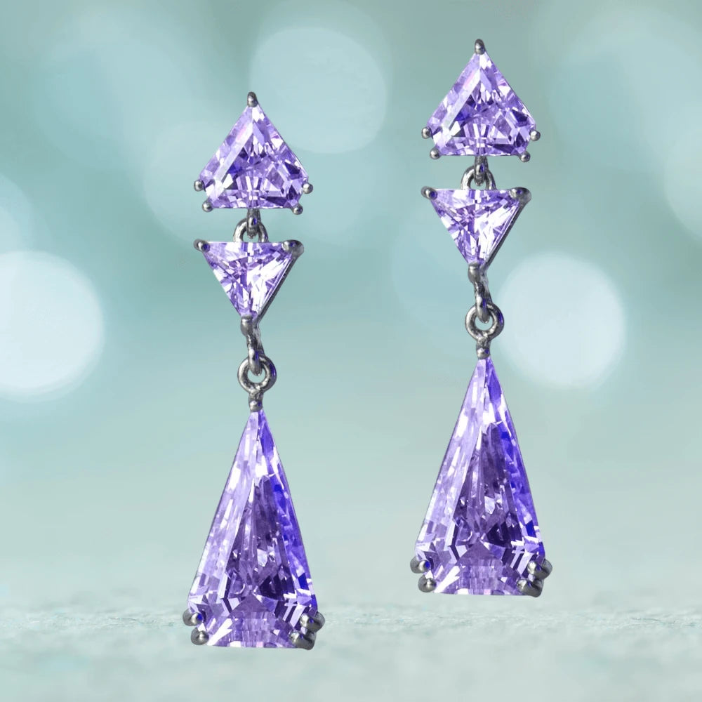 Deco Chadelier Earrings featuring three faceted purple gemstones in sterling silver with rhodium plating, designed for a refined female jewelry collection.