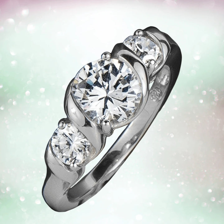 Solitaire Twist Ring in rhodium-plated sterling silver featuring a large central sparkling stone flanked by two smaller stones, designed for female jewelry lovers.