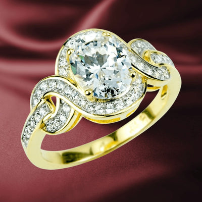 Isola Ring crafted in sterling silver with gold plating, featuring an elegant design with a large central gemstone surrounded by smaller sparkling stones, perfect female jewelry.