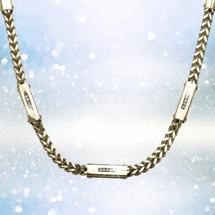 Quadrant Steel Necklace in gold-plated stainless steel for men, featuring a sleek chain design with three embedded sparkling accents against a shimmering background.
