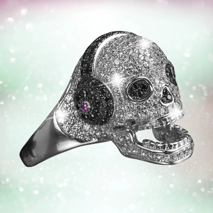 Sterling silver DJ Skull ring for female with rhodium plating, featuring a sparkling skull design accented with black and purple stones, perfect collectible jewelry.