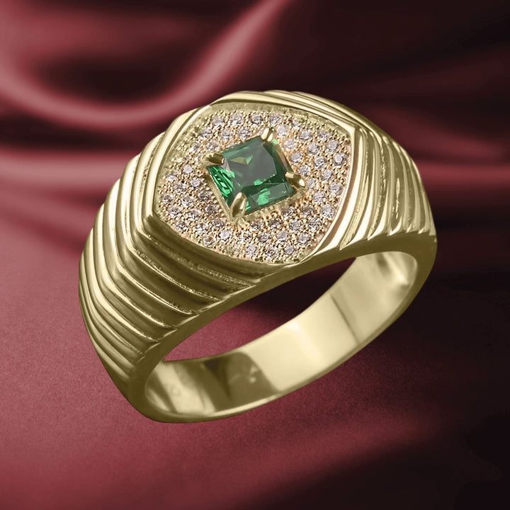 Skorpios Ring featuring a gold plated sterling silver band with a square green gemstone centerpiece surrounded by small sparkling stones, designed for men’s jewelry.