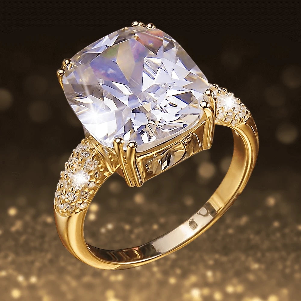 Dazzle Ring Gold featuring a large clear gemstone set in a gold-plated sterling silver band with intricate sparkling side details, designed for women’s jewelry collection.