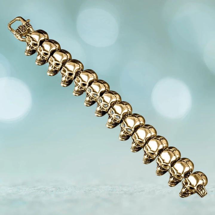Skullhead Gold Bracelet featuring linked gold-tone skulls crafted from stainless steel, designed for men seeking bold and distinctive jewelry pieces.
