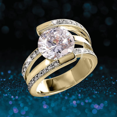 Rodela Gold Ring featuring a large sparkling center stone set in sterling silver with gold plating, accented by smaller clear stones, designed for female jewelry enthusiasts.