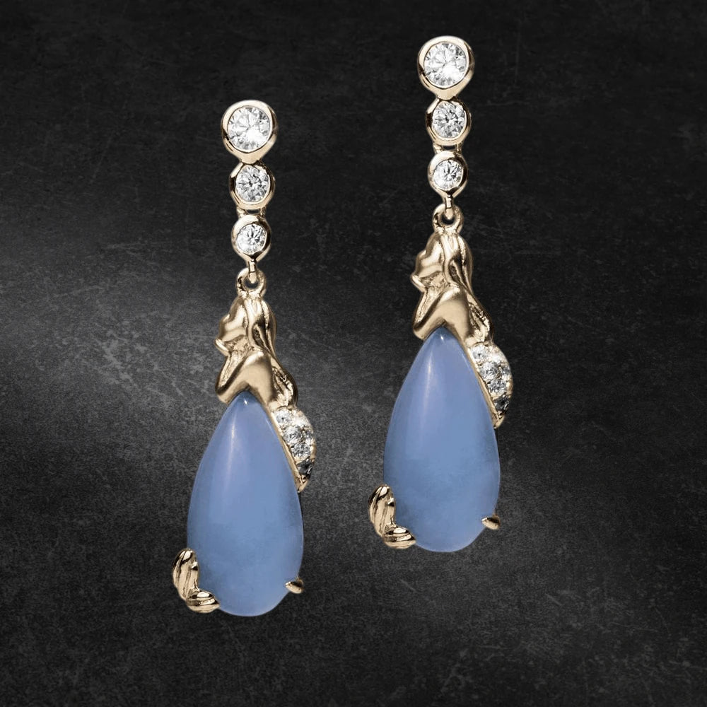 Pair of Mermaid Lagoon Earrings featuring gold-plated sterling silver mermaid design with blue teardrop stones and sparkling round crystals, elegant jewelry for women.