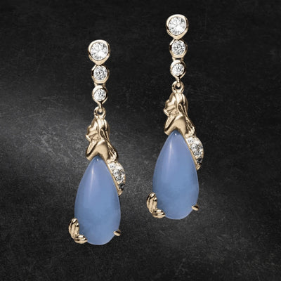 Pair of Mermaid Lagoon Earrings featuring gold-plated sterling silver mermaid design with blue teardrop stones and sparkling round crystals, elegant jewelry for women.
