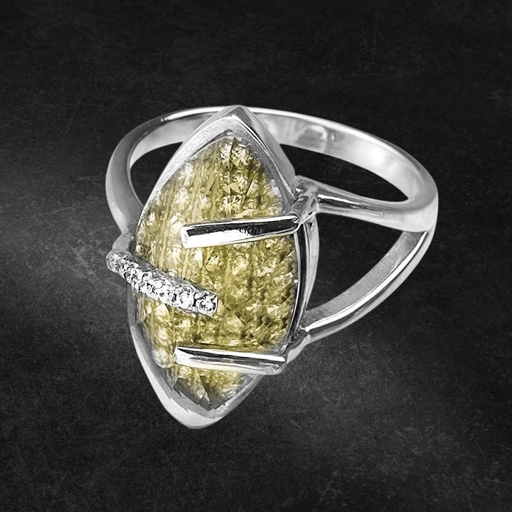Captured Ring featuring a sterling silver band with rhodium plating, designed for women, showcasing a marquise-shaped yellow textured stone accented by small clear crystals.