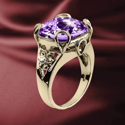 Golden Fascination Ring featuring a large purple gemstone set in gold-plated sterling silver with intricate floral detailing, designed for women’s jewelry collections.