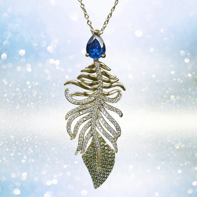 Peacock Pendant featuring a gold-plated sterling silver feather design with sparkling stones and a deep blue gemstone accent, elegant jewelry for women.