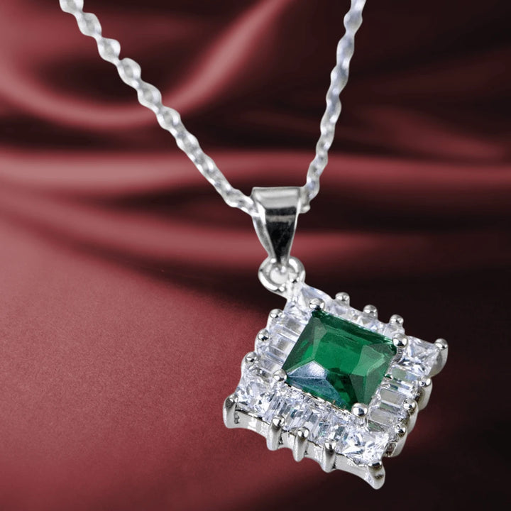 Gatsby Pendant featuring a sterling silver rhodium-plated chain with a square green gemstone surrounded by clear crystals, designed for female jewelry enthusiasts.