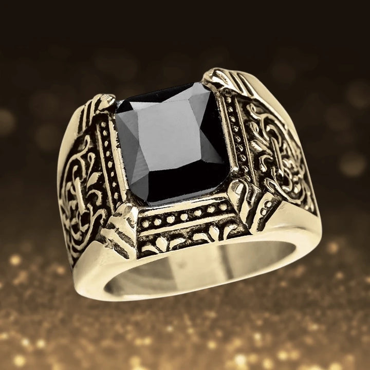 Caesar Nero Ring featuring a gold-plated stainless steel band with intricate detailing and a large black square gemstone, designed for men’s jewelry.