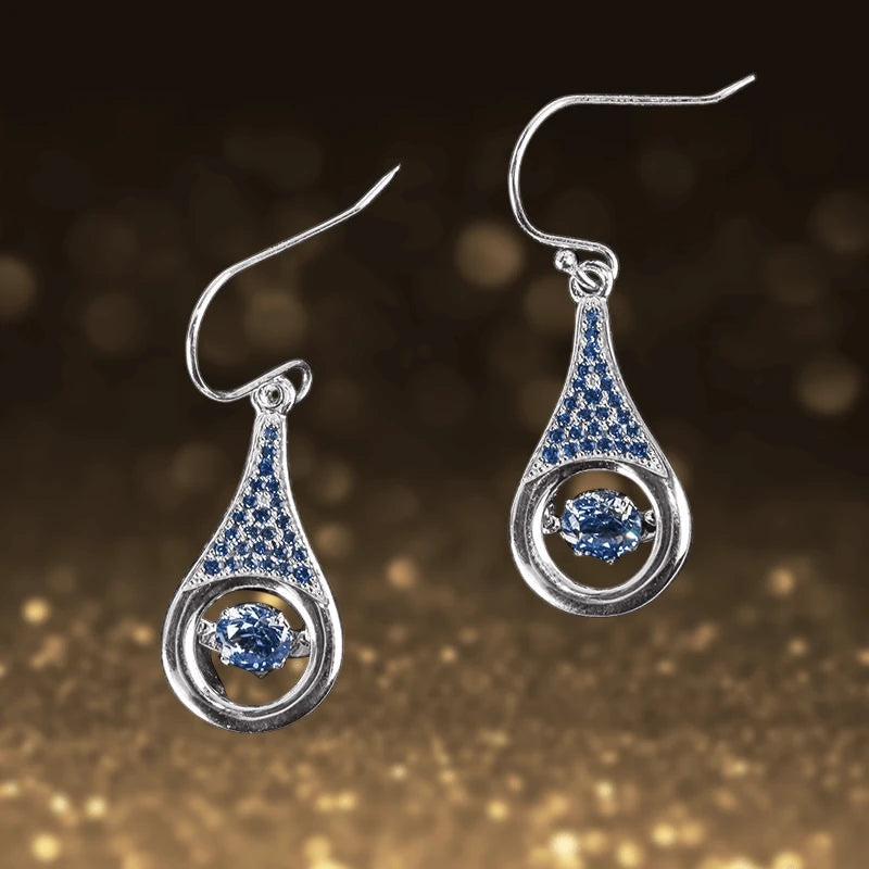 Indigo Dancing Earrings featuring sterling silver with rhodium plating, showcasing a teardrop design with indigo stones that capture light beautifully for a sophisticated female jewelry piece.