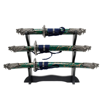 Jade Dragon Sword Set displayed on a black stand featuring intricate dragon designs and green blades with decorative handles, Up To 75% Off Retail.
