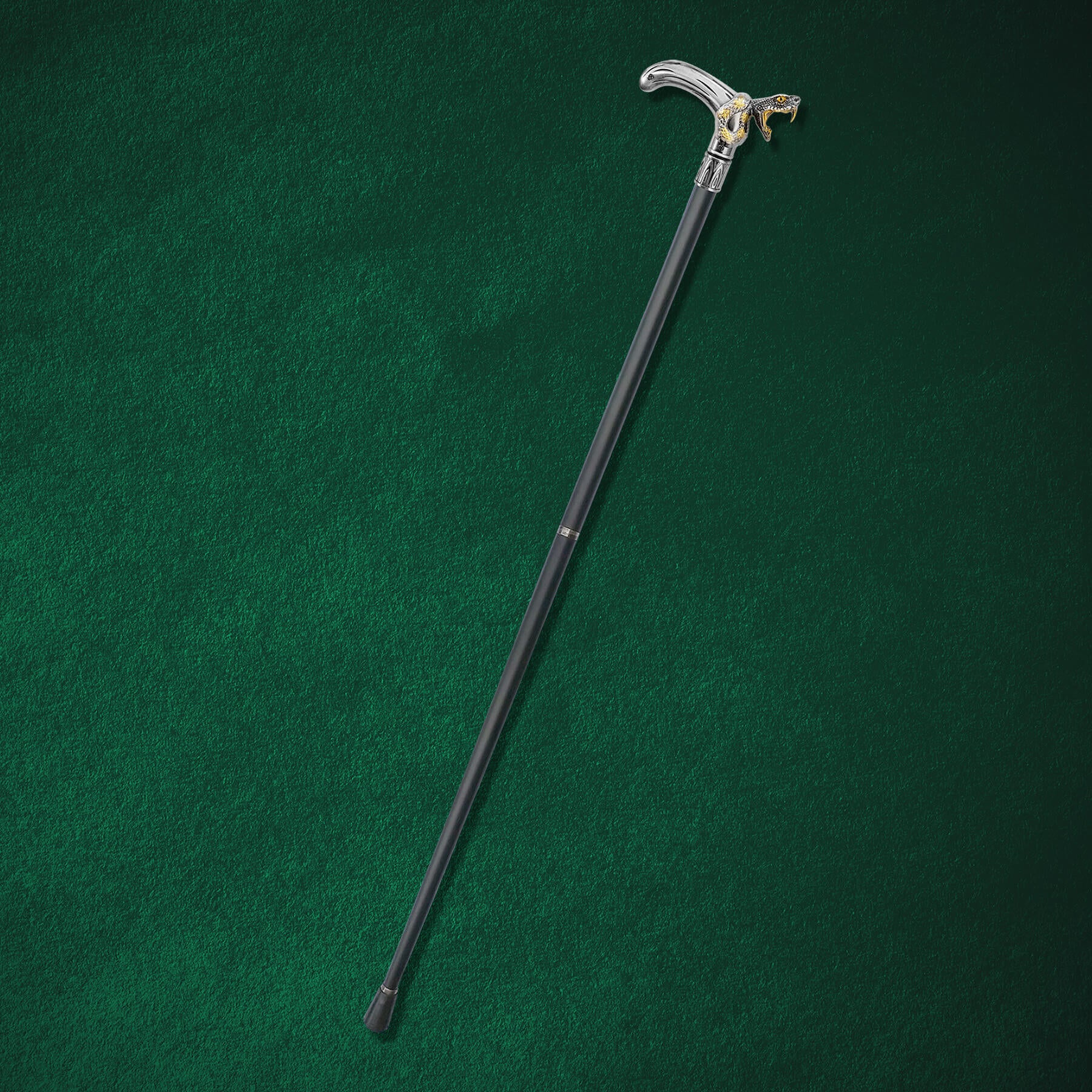 Black Fang Walking Cane with a sleek black shaft and a silver handle featuring a detailed wolf head design, resting on a dark green surface.