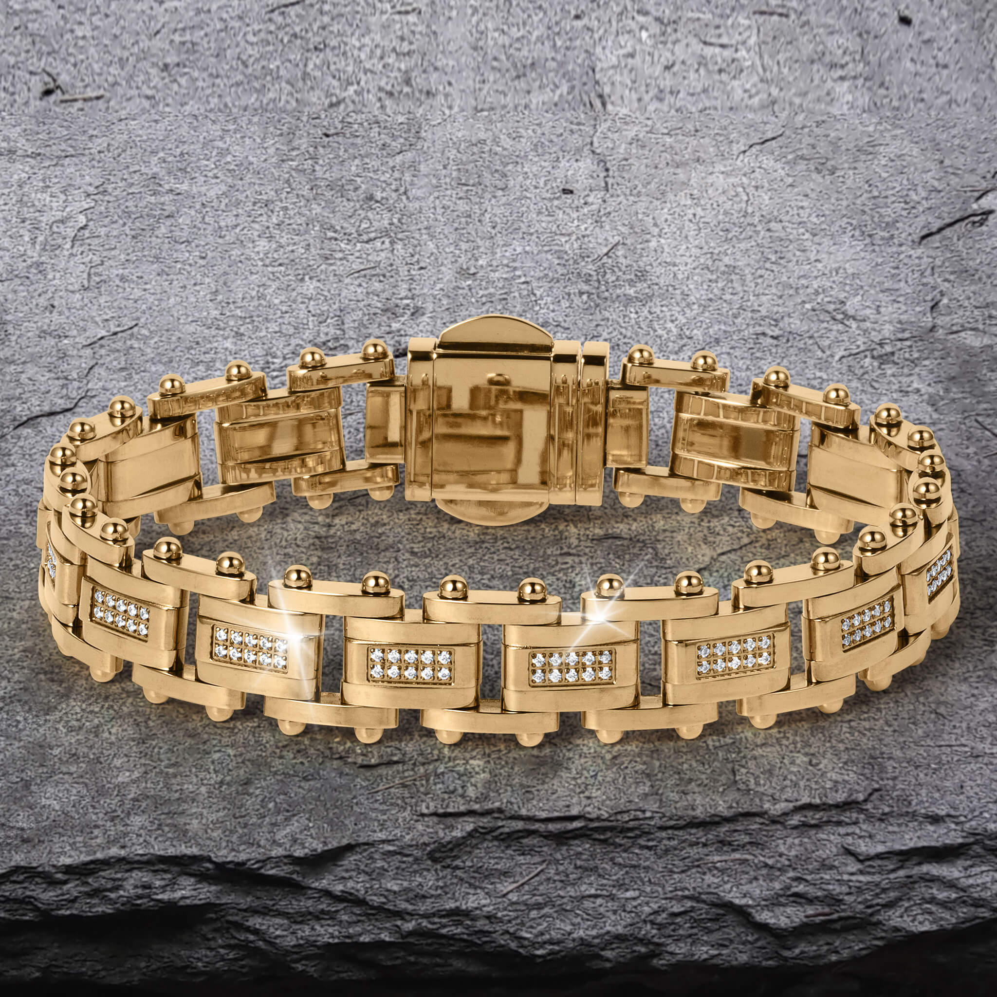 Imperial Link Bracelet featuring a gold-toned metal design with rectangular links adorned with small sparkling stones, displayed on a textured stone surface.