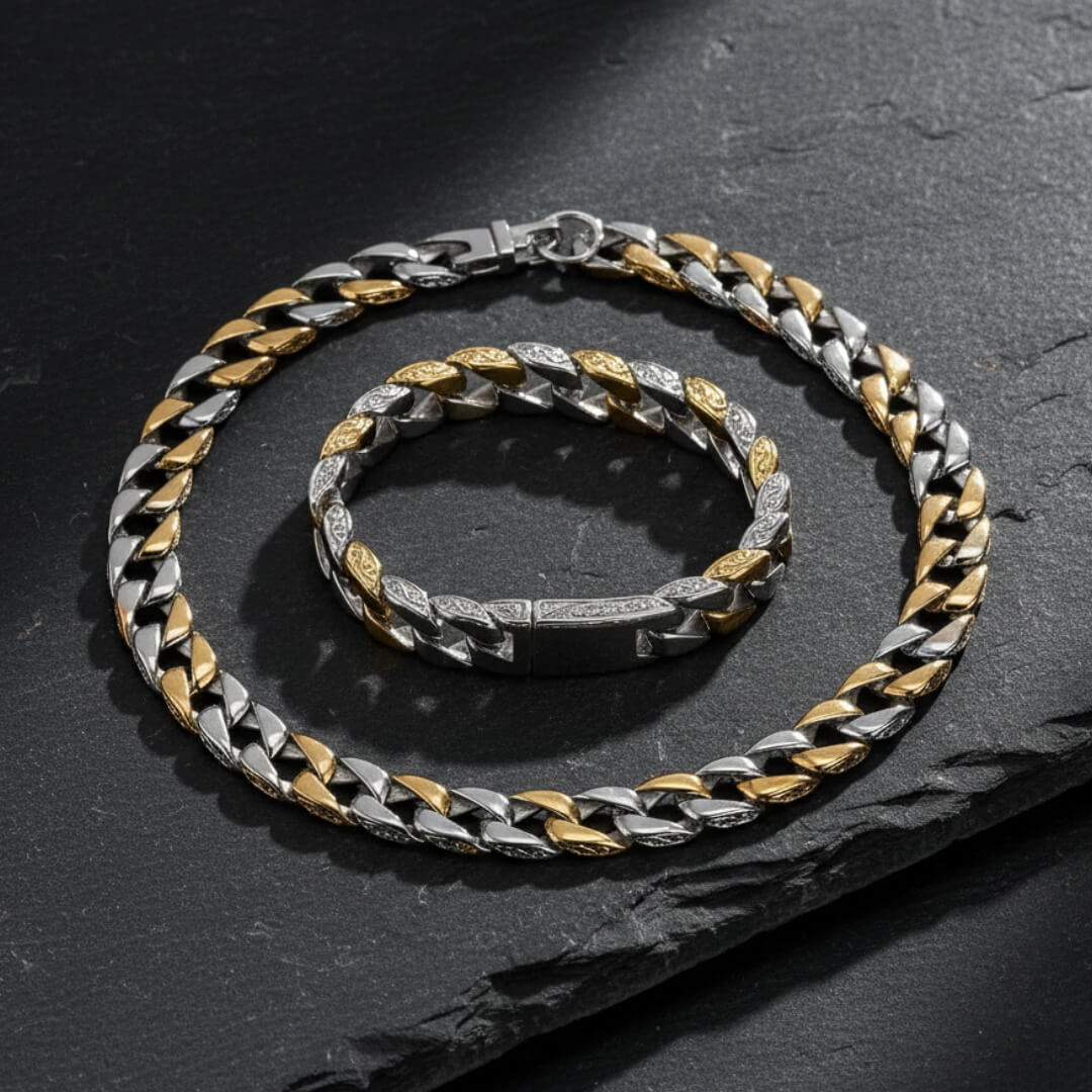 Two silver and gold chain necklaces on a dark surface. Curb Vine Men's Set by Daniel Steiger