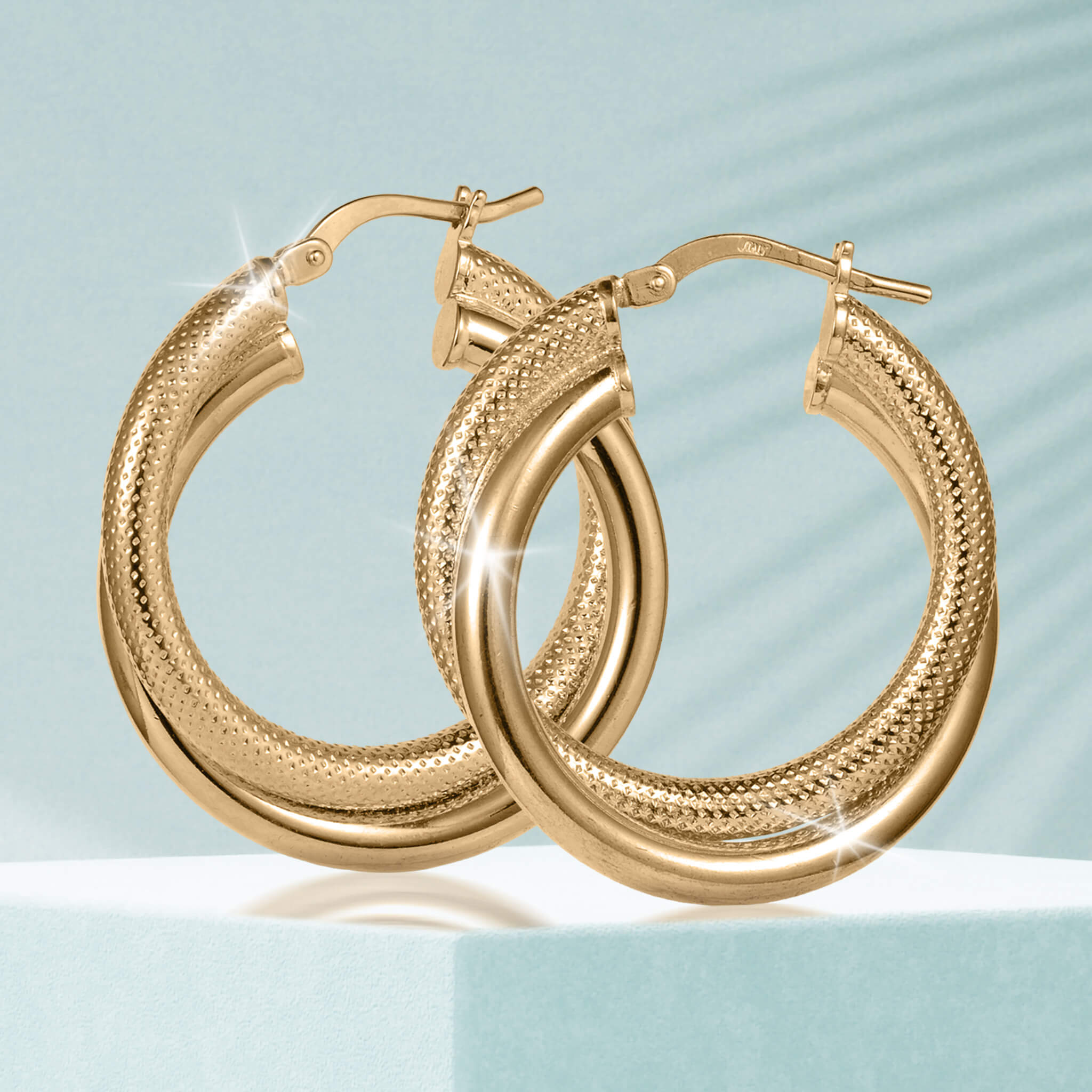 Lucente Hoop Round Earrings in polished gold-tone finish featuring a textured outer surface, designed for a stylish and elegant jewelry look.