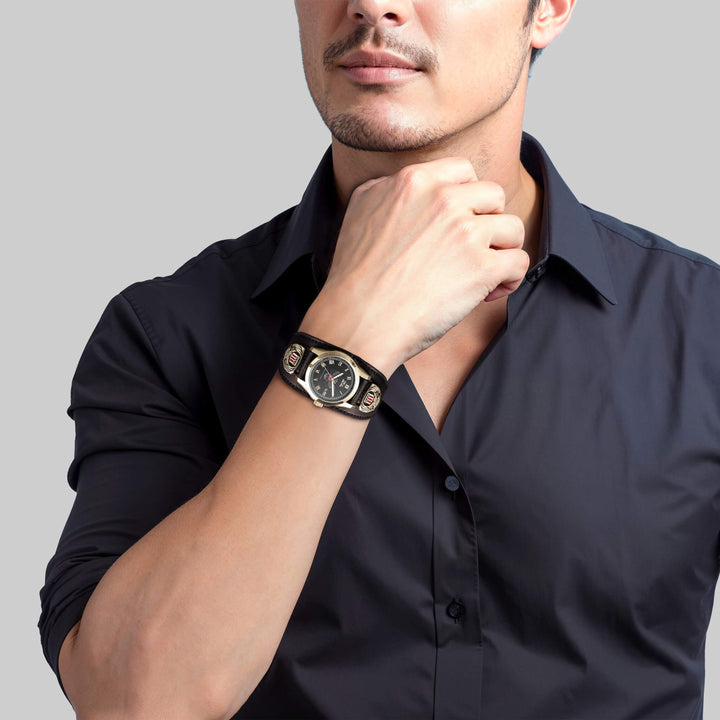 Man wearing a Patriot Men's Watch with a black dial, gold plating, and stainless steel material, paired with a black dress shirt in a professional setting.