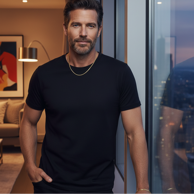 Man wearing a black t-shirt standing in a room with a cityscape view.