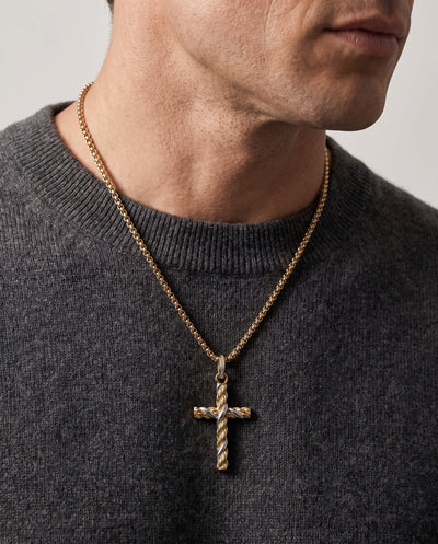 Man wearing a gold Entwinned Cross Pendant necklace with a textured twisted design on a gold chain over a dark gray sweater, up to 75% off retail.