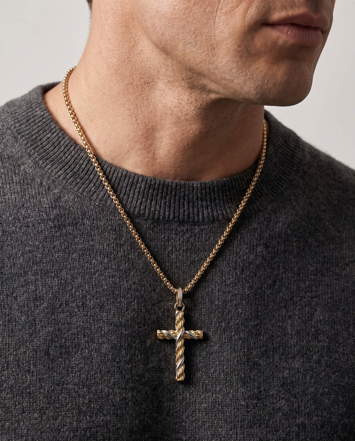 Man wearing a gold Entwinned Cross Pendant necklace with a textured twisted design on a gold chain over a dark gray sweater, up to 75% off retail.