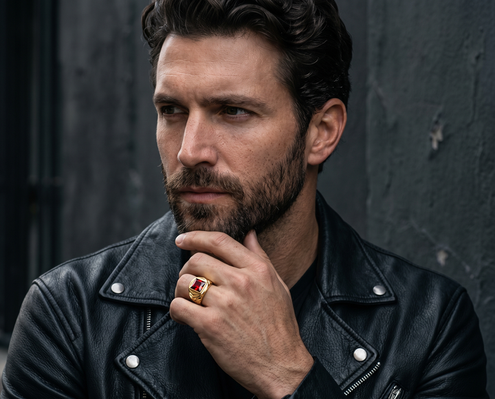 Obsedia Men's Ring featuring a bold red and gold centerpiece worn by a bearded man in a black leather jacket for a refined statement jewelry look