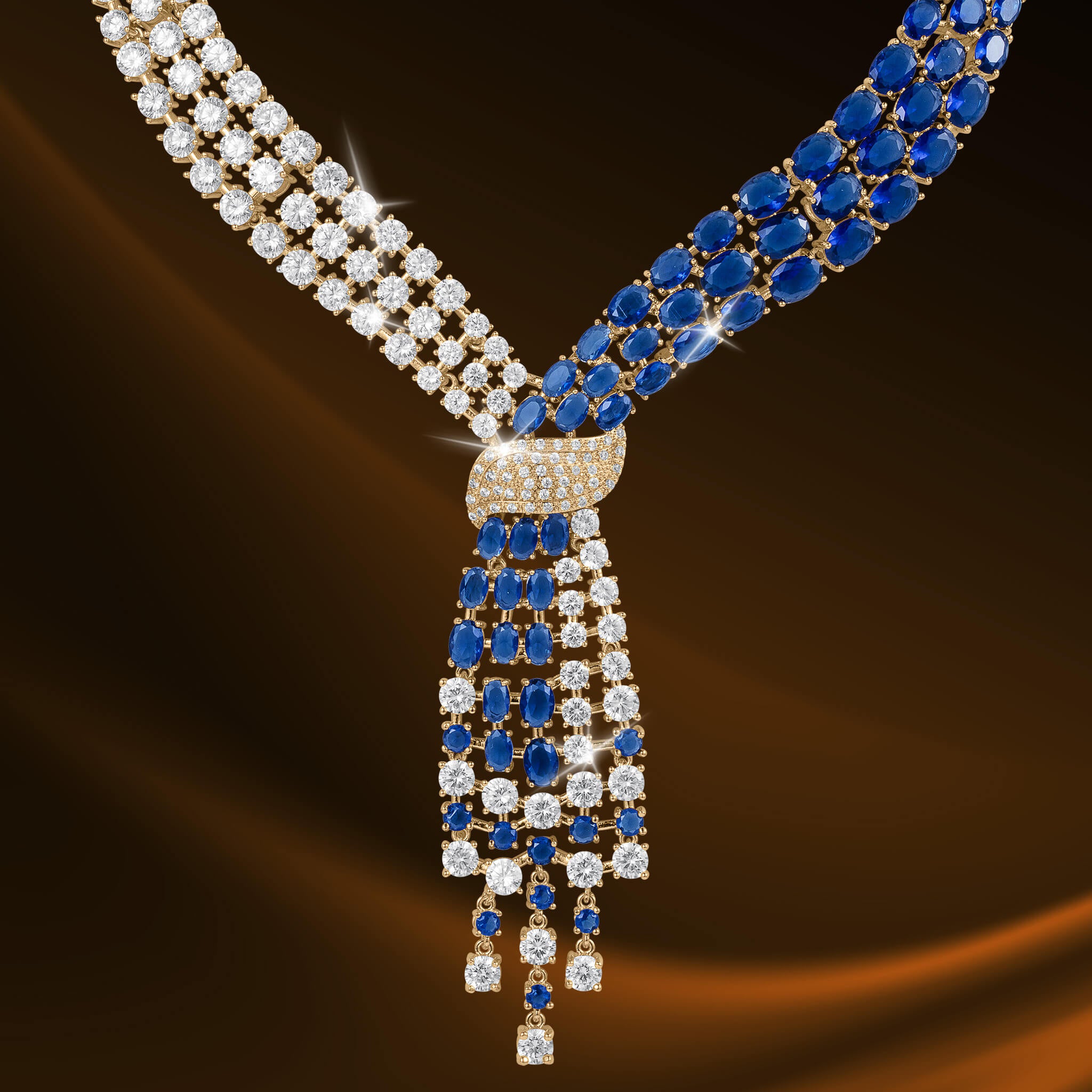 Elegant necklace featuring sparkling white diamonds and deep blue gemstones intertwined with a gold clasp from the Royal Tide Collection