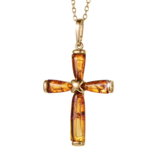 Gold and amber cross pendant on a white background