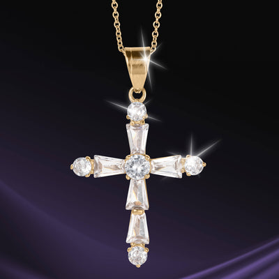 Celestial Light Cross Pendant in gold tone with brilliant faceted stones on a chain against a dark background Up To 75% Off Retail