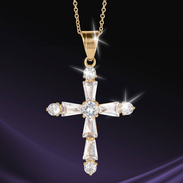 Celestial Light Cross Pendant in gold tone with brilliant faceted stones on a chain against a dark background Up To 75% Off Retail
